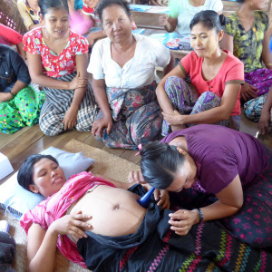 A birth attendant supports a pregnant woman in Burma