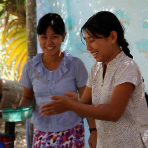 Two women washing their hands